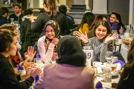 Pakistani Fulbright students talk over dinner.