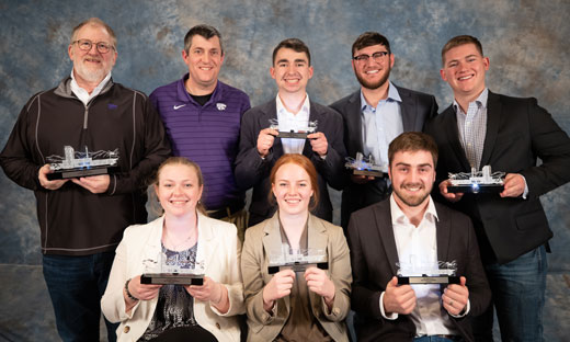 Team members and advisors with their trophies 