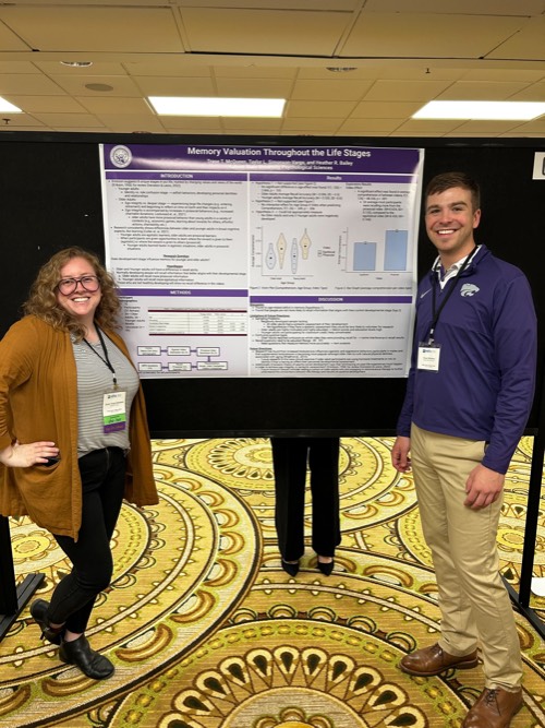 taylor standing with trase in front of his research poster at MPA 2024