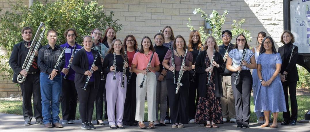 members of the clariet studio standing outside on a sunny day with their clarinets