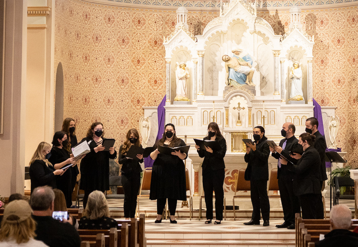 singers performing in front of a large altar