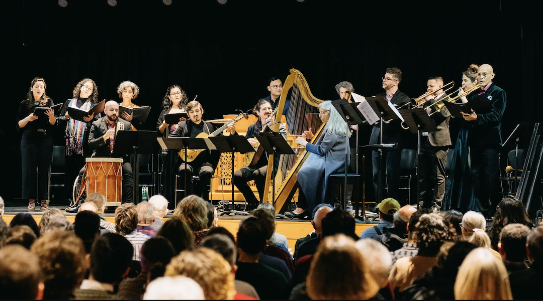 musicians sit on a stage