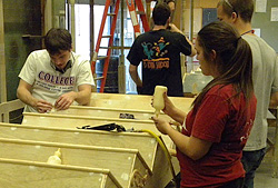 students work in the scene shop with pieces of wood