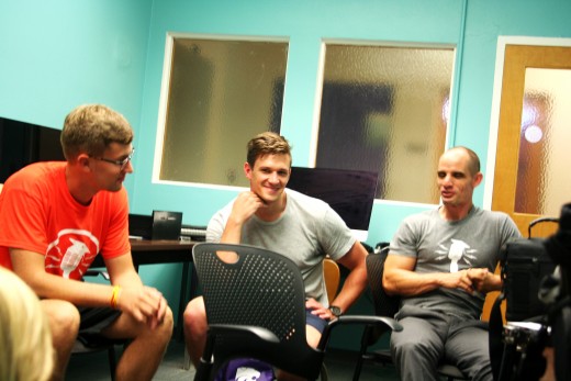 Three people sitting in a radio production studio. Two are young male students and one is professor Mike Wesch, creator of the "Life 101" poscast.