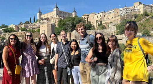 group posed in front of castle in Spain