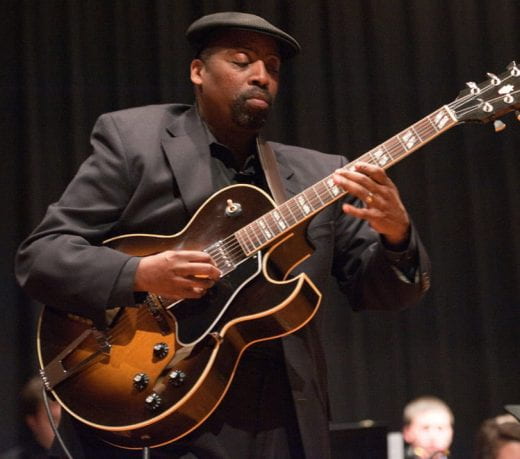 photo of Dr. Wayne Goins playing guitar