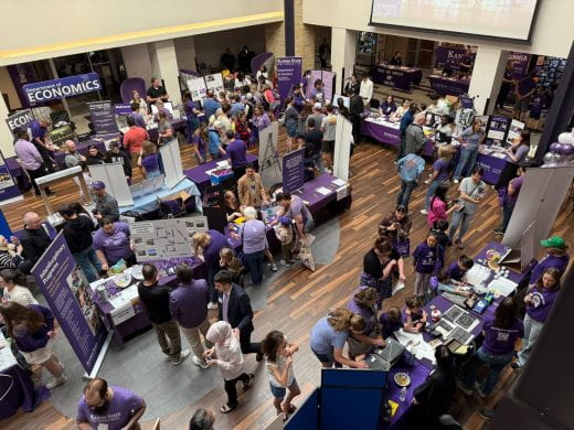 photo of lots of people browsing department exhibits at the college's academic expo in the Unioncourtyard