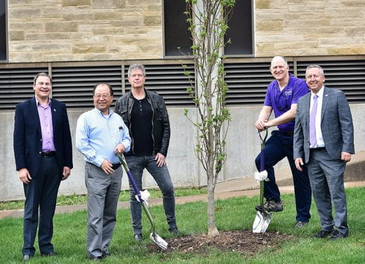 Roots of Research Awardee Jun Li and others holding ceremonial shovels near tree