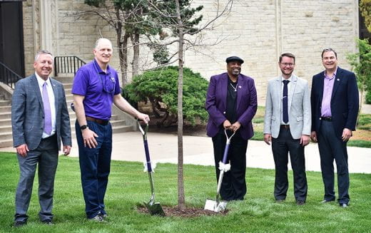 Roots of Research Awardee Wayne Goins and others holding ceremonial shovels near tree