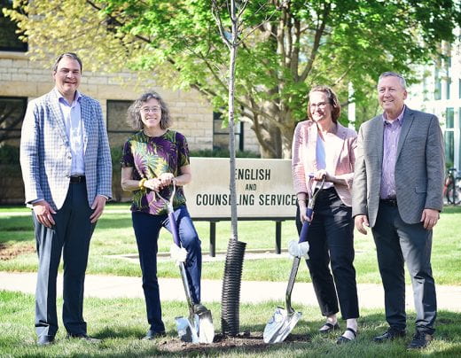 Roots of Research Awardee Elizabeth Dodd and others holding ceremonial shovels near tree