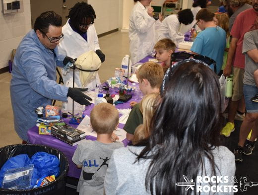 Kids visit K-State Chemistry exhibit full of experiment items and equipment