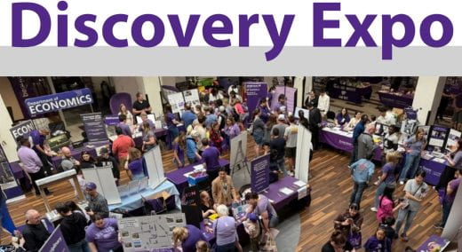 Photo from high above of people viewing department exhibits