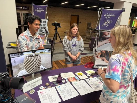 Art dept rep talks to student at 2025 Arts and Sciences Discovery Expo