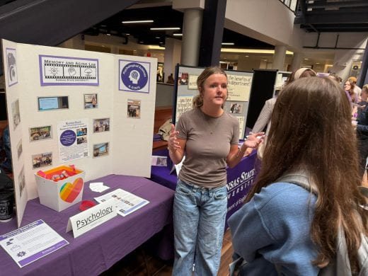 Psychological sciences dept rep talks to student at 2025 Arts and Sciences Discovery Expo