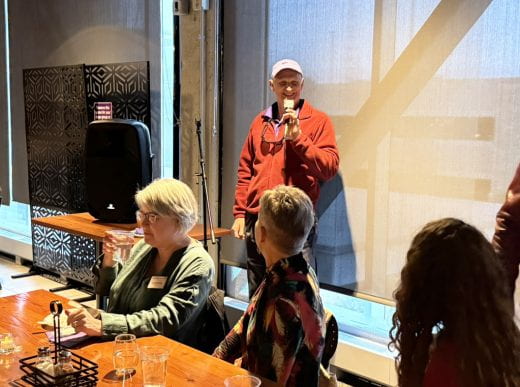 Dean Culbertson addresses party holding microphone