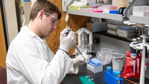 student pipetting in lab