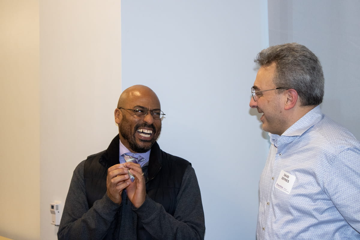 two award celebration guests chatting and smiling