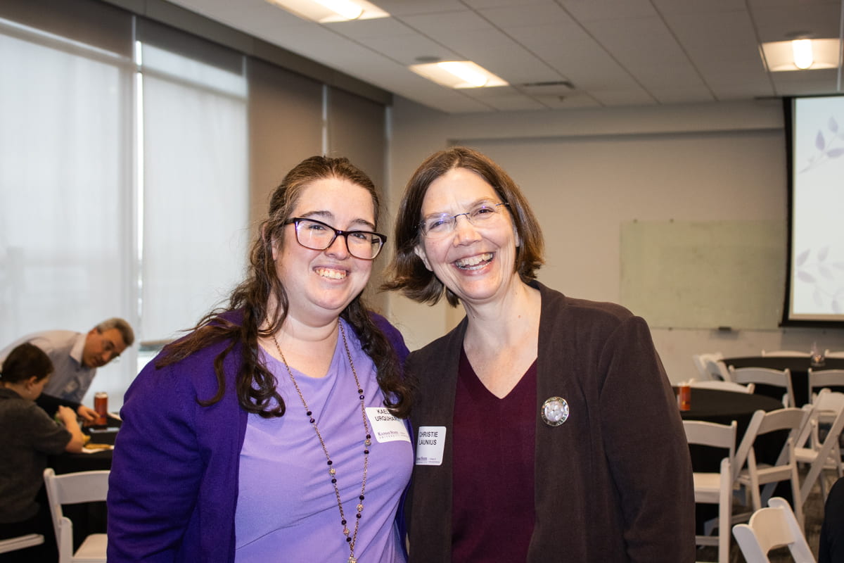 two award celebration guests posed and smiling together