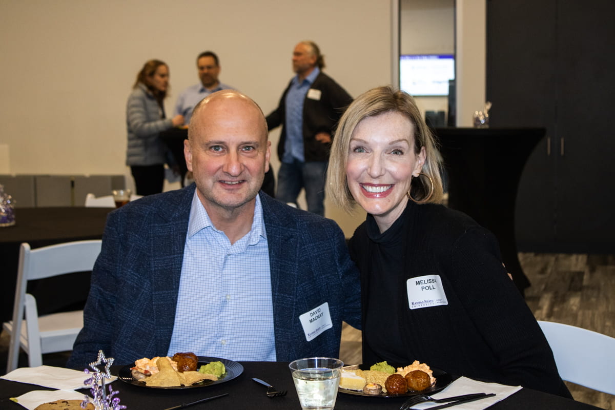 two award celebration guests posed and smiling together