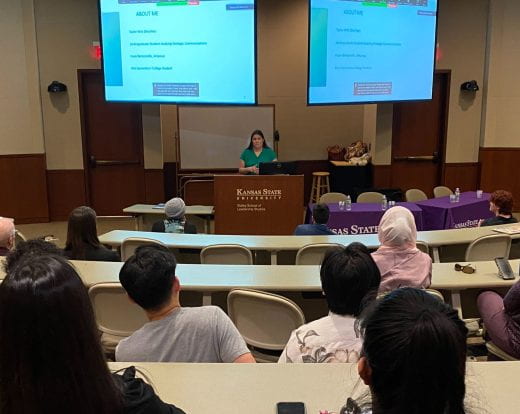Taylor Witt presenting to students in audience