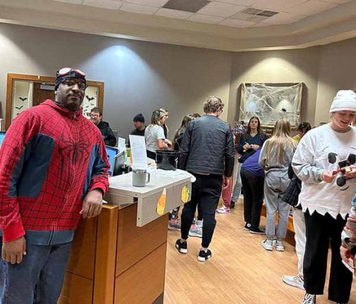 people in the office, including Frank dressed as Spider Man