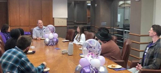 Photo of Dean Chris Culbertson and students sitting at table