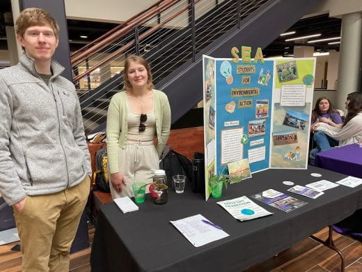 Representatives of Students for Environmental Action at their exhibit