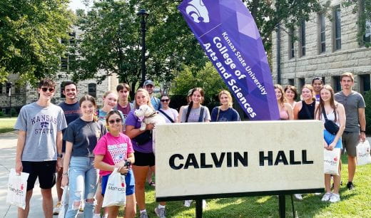 Photo of students gathered by Calvin Hall sign