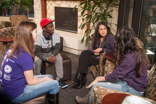 Photo of 4 people sitting and chatting together