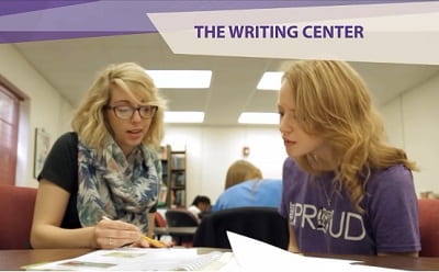 Photo of two people looking at paper on a table, plus text that says The Writing Center.