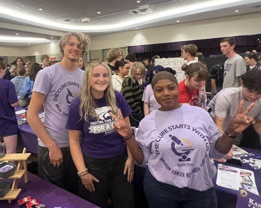 Cats for a Cure students smiling big and surrounded by lots of other students in Union