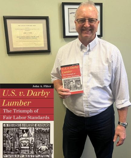 John Fliter holding his new book