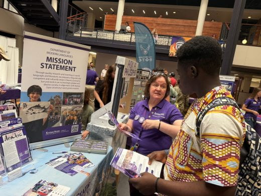 Modern Languages rep talks to student at 2025 Arts and Sciences Discovery Expo
