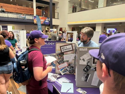 Sociology, Anthropology, and Social Work dept rep talks to student at 2025 Arts and Sciences Discovery Expo
