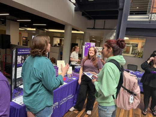 AQ Miller School of Media and Communication rep talks to student at 2025 Arts and Sciences Discovery Expo
