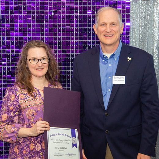 Stacia Gray holding award certificate next to Dean Chris Culbertson
