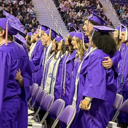 students sing alma mater arm-in-arm
