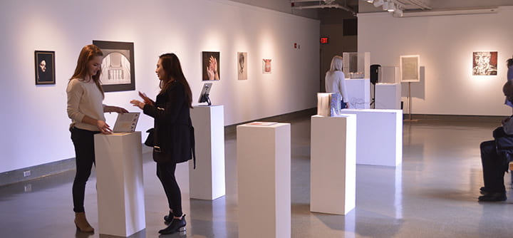 people chatting and viewing artworks in Chapman Gallery