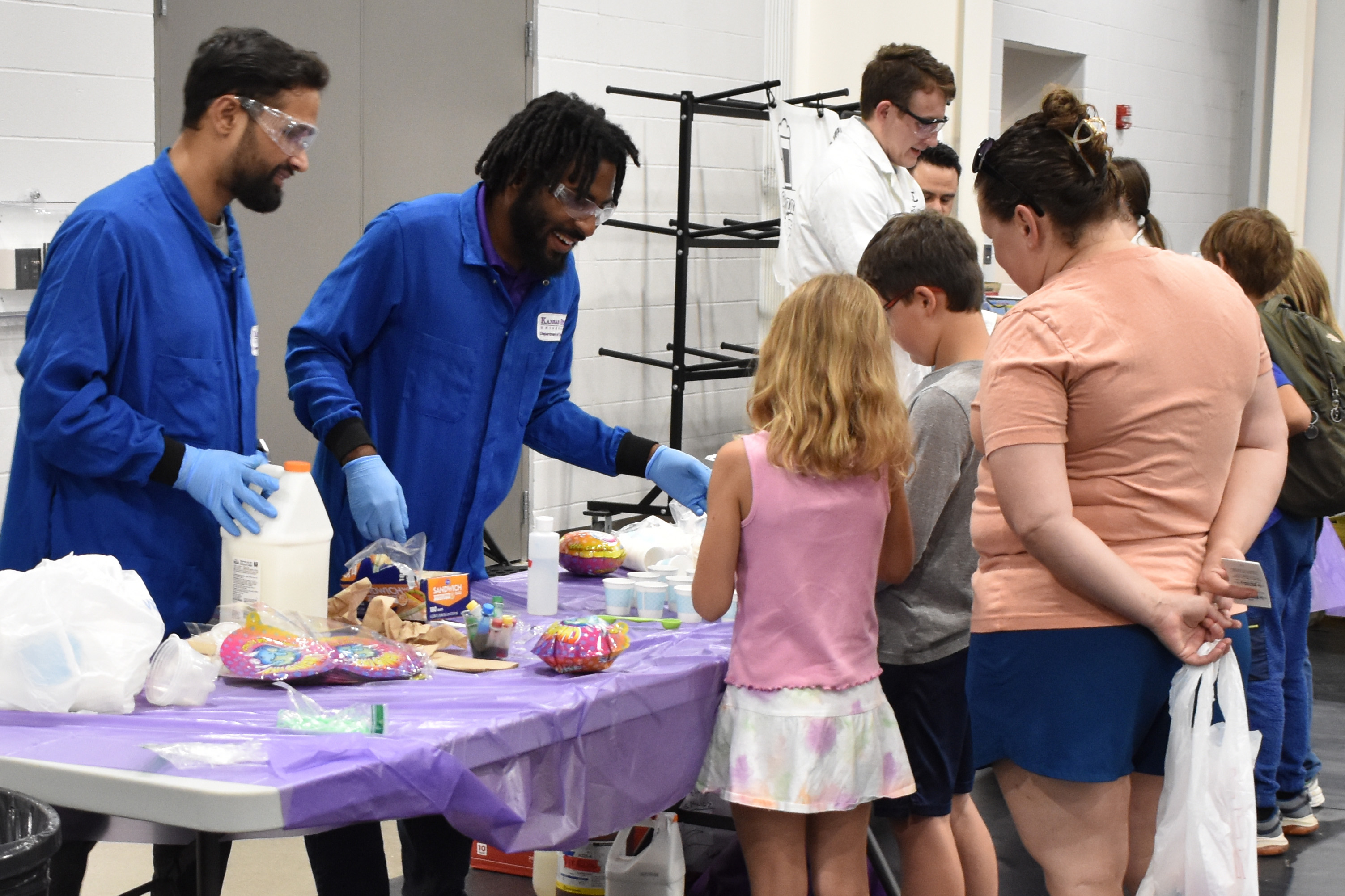 educators and youth chat at chemistry booth