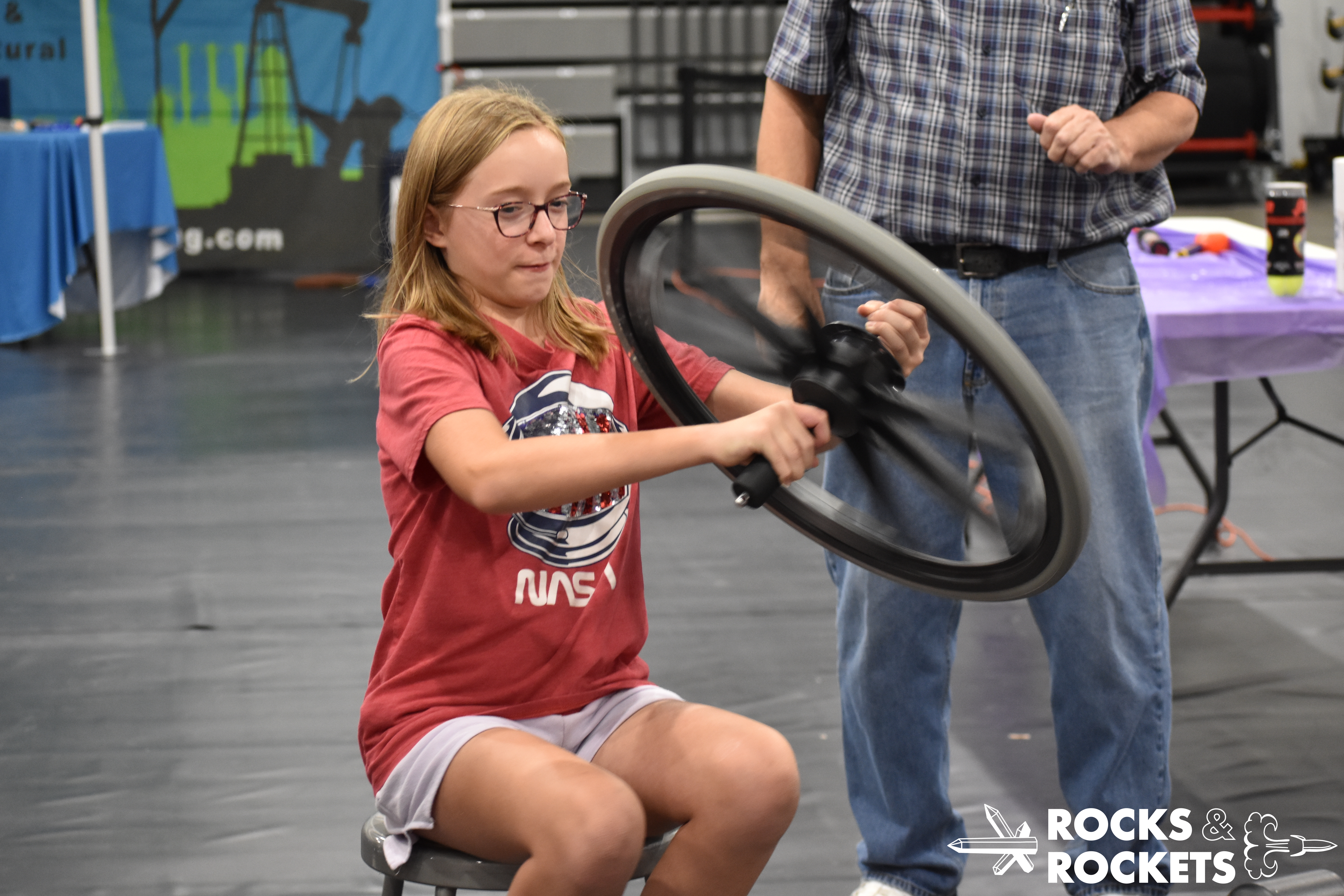 participant spins a wheel at the physics demonstration