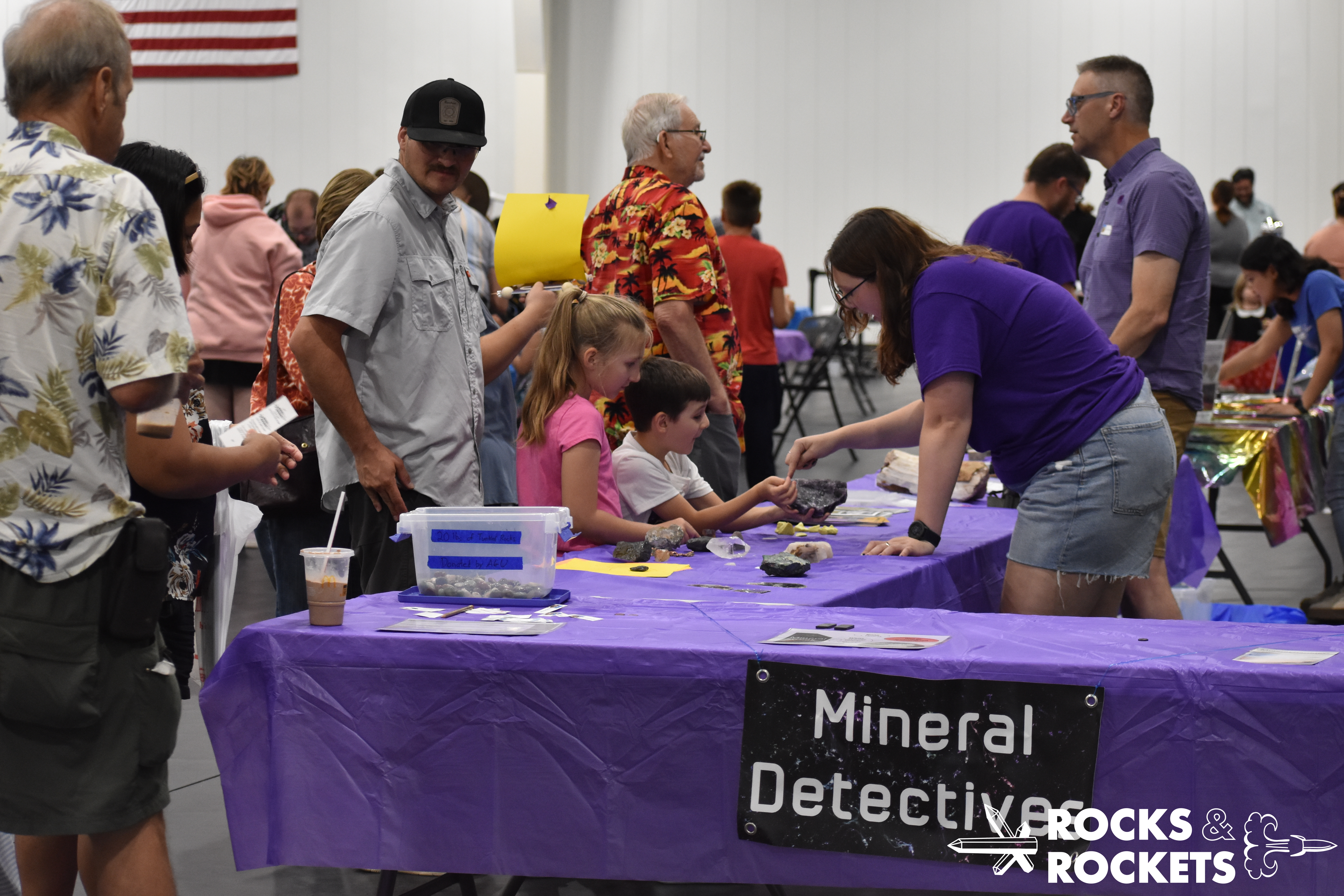 educators and youth interact at geology table