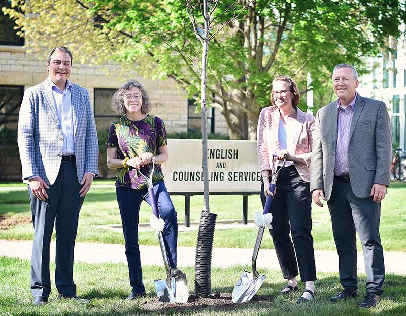 Hans Coetzee, Elizabeth Dodd, Karin Westman and President Richard Linton stand near tree with shovels