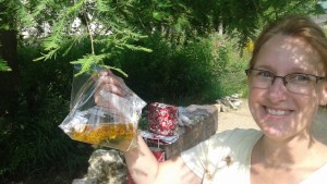 Dr. Haar holding up a quick test of Asclepias tuberosa liquor (flowers + warm water). Image by Katie Kingery-Page