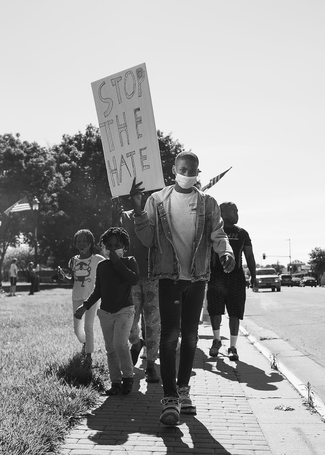 Black and white photograph entitled “Will the hate end?” by Doug Barrett from the collection of the Beach Museum of Art.