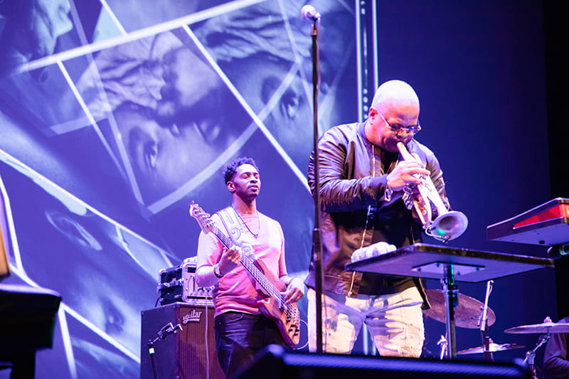 Photo of concert with trumpet and guitar players