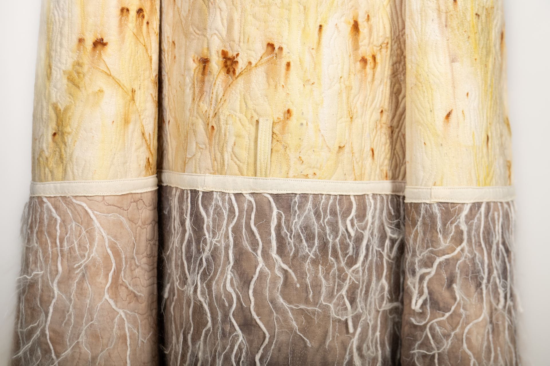 Detail image of a cloak by fiber artist Sherry Haar in the "Above and Below" series. Created using botanical printing process.