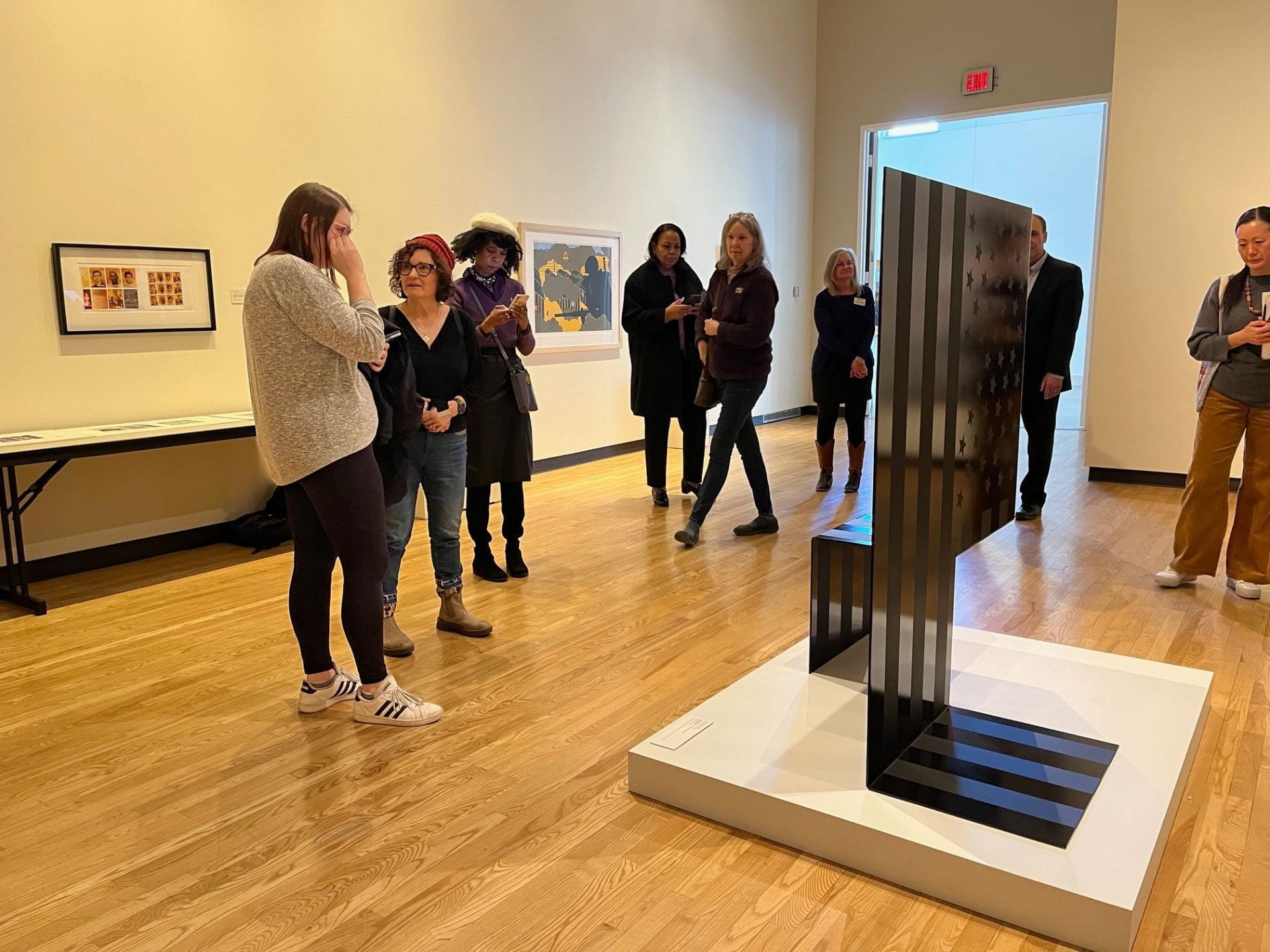 Gallery program with participants viewing works in an exhibition at the Beach Museum of Art.
