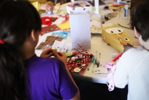 Families engaged in making gifts and decorations at the Holiday Workshop at the Beach Museum of Art.
