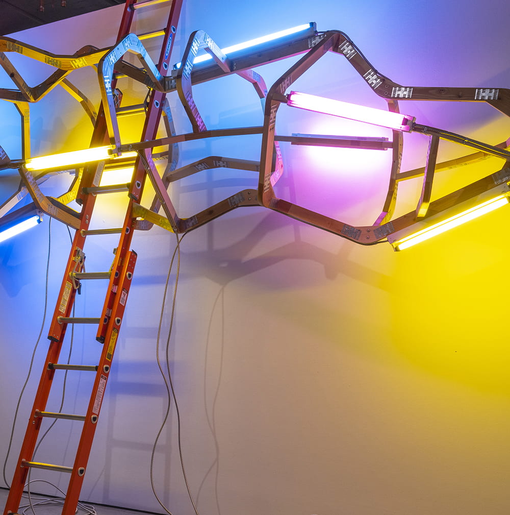 Mark Cowardin, "Just Passing Through...Again" (detail), ladders, 2x4s, hardware, lights and electrical components. Image courtesy of the artist