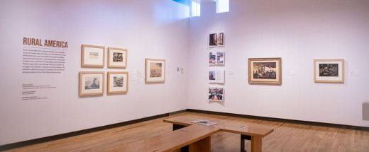 Exhibition gallery with several artworks displayed on walls.